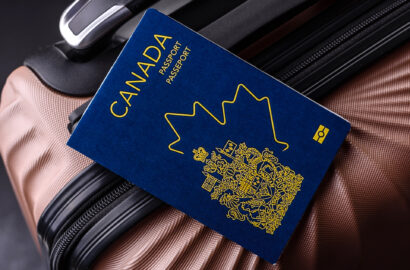 International passport of a citizen of Canada on a suitcase, departure from the airport, international travel